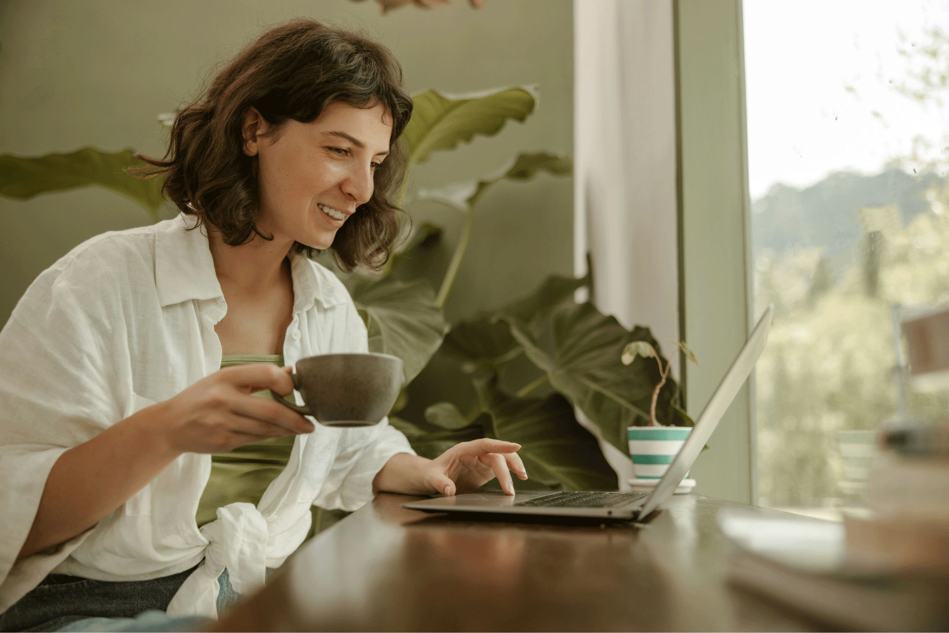 Happier buyers: Buyer smiling while shopping a branded merch store on a laptop
